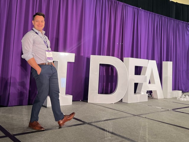 Man standing near sign